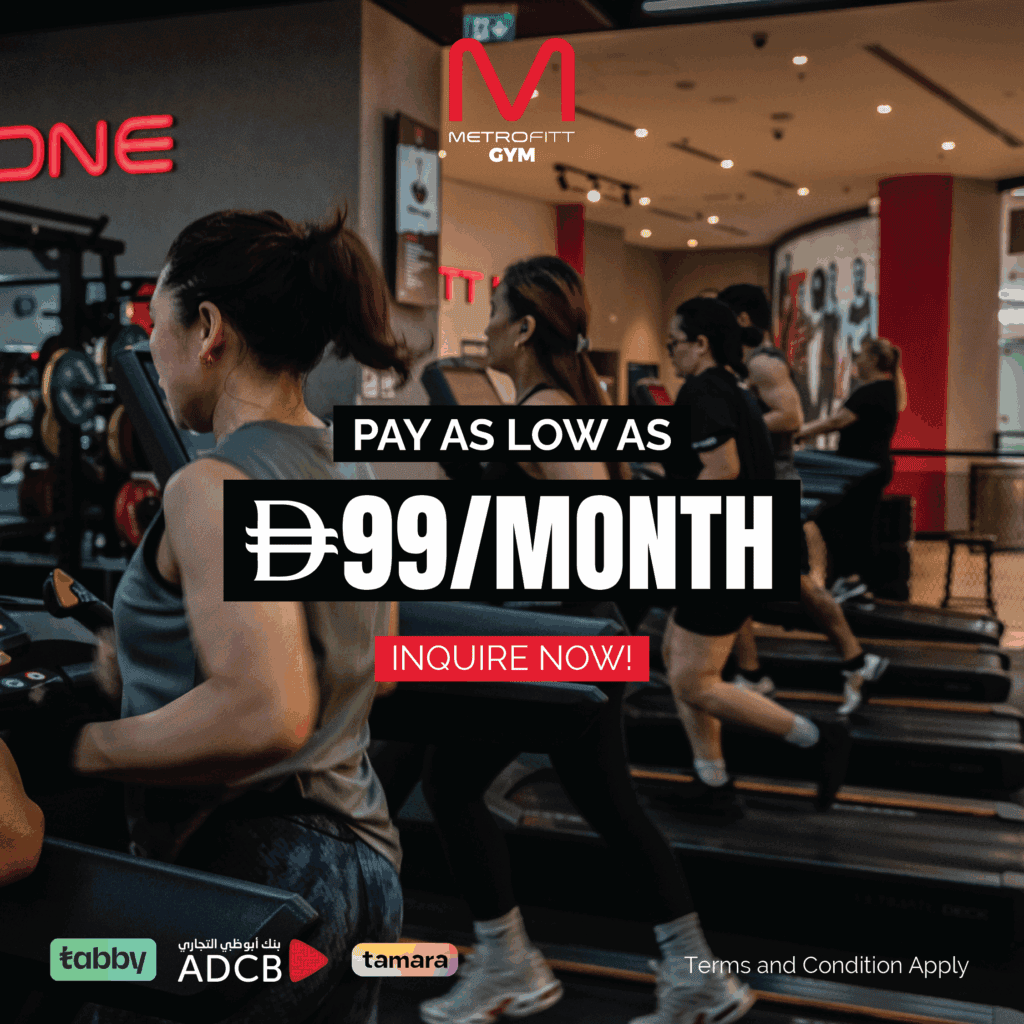 Promotional image for METROFITT Gym showing people running on treadmills inside a modern gym facility. The text overlay reads “Pay As Low As AED 99/Month – Inquire Now!” with logos for payment partners Tabby, ADCB, and Tamara. The METROFITT Gym logo is displayed at the top, and a disclaimer at the bottom reads “Terms and Condition Apply.”