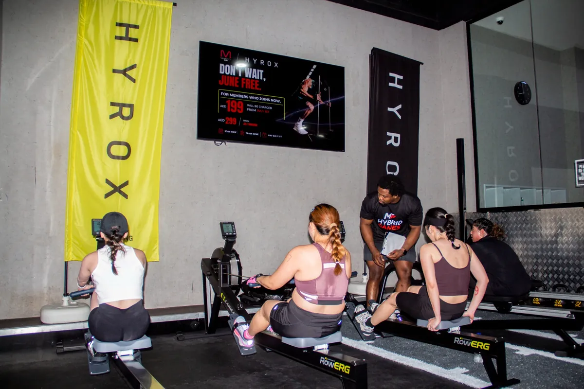 Participants taking part in a HYROX rowing workout challenge at METROFITT Al Ghurair Centre.